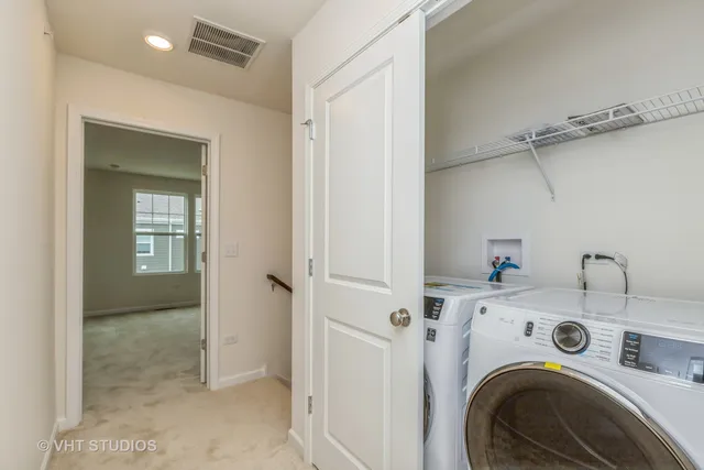 a view of storage and utility room with washer and dryer