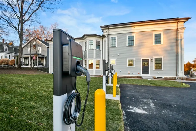 a view of a house with a backyard and a tree