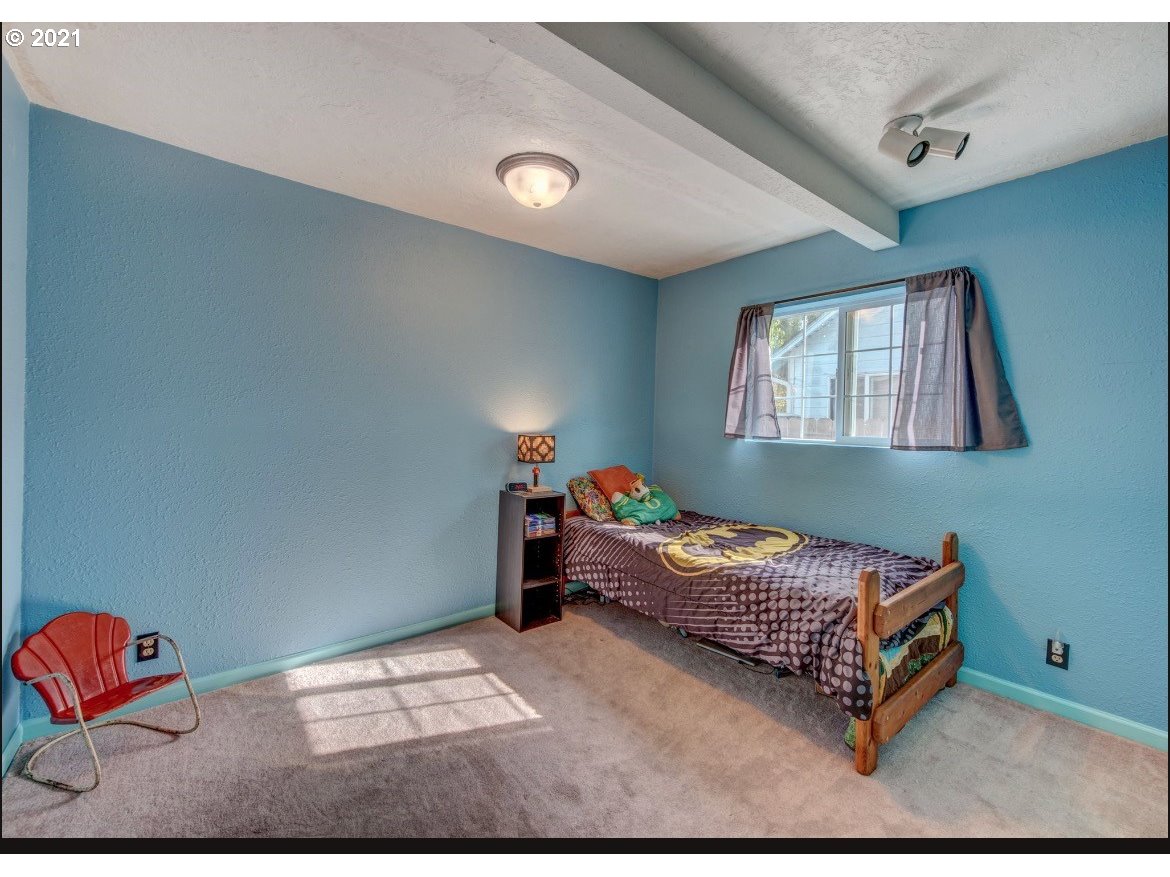 756 North 23rd Street Springfield, OR 97477 - Photo 12 of 22 a bedroom with bed and window