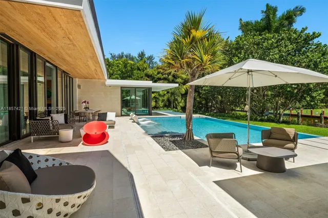 a view of a house with swimming pool and sitting area
