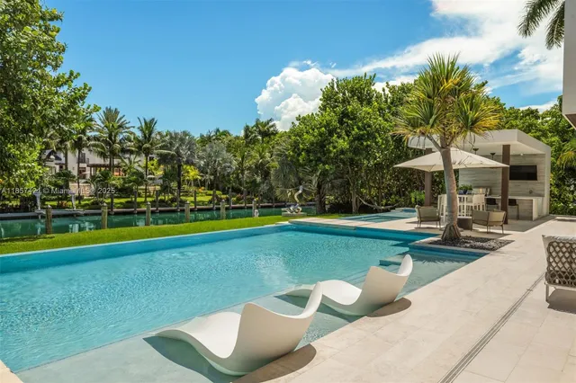 a view of a house with backyard porch and sitting area