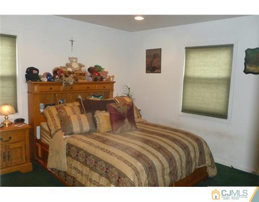 161 East Hill Road Colonia, NJ 07067 - Photo 11 of 16 a bedroom with a bed and wooden floor
