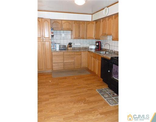 161 East Hill Road Colonia, NJ 07067 - Photo 5 of 16 a kitchen with a sink cabinets and a window