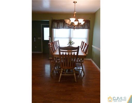 161 East Hill Road Colonia, NJ 07067 - Photo 6 of 16 a view of a dining room with furniture and chandelier