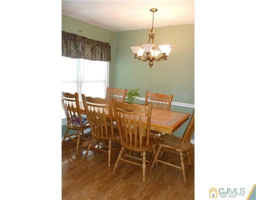 161 East Hill Road Colonia, NJ 07067 - Photo 8 of 16 a view of a dining room with furniture and wooden floor