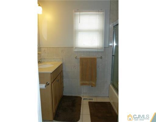 161 East Hill Road Colonia, NJ 07067 - Photo 9 of 16 a bathroom with a sink and a vanity