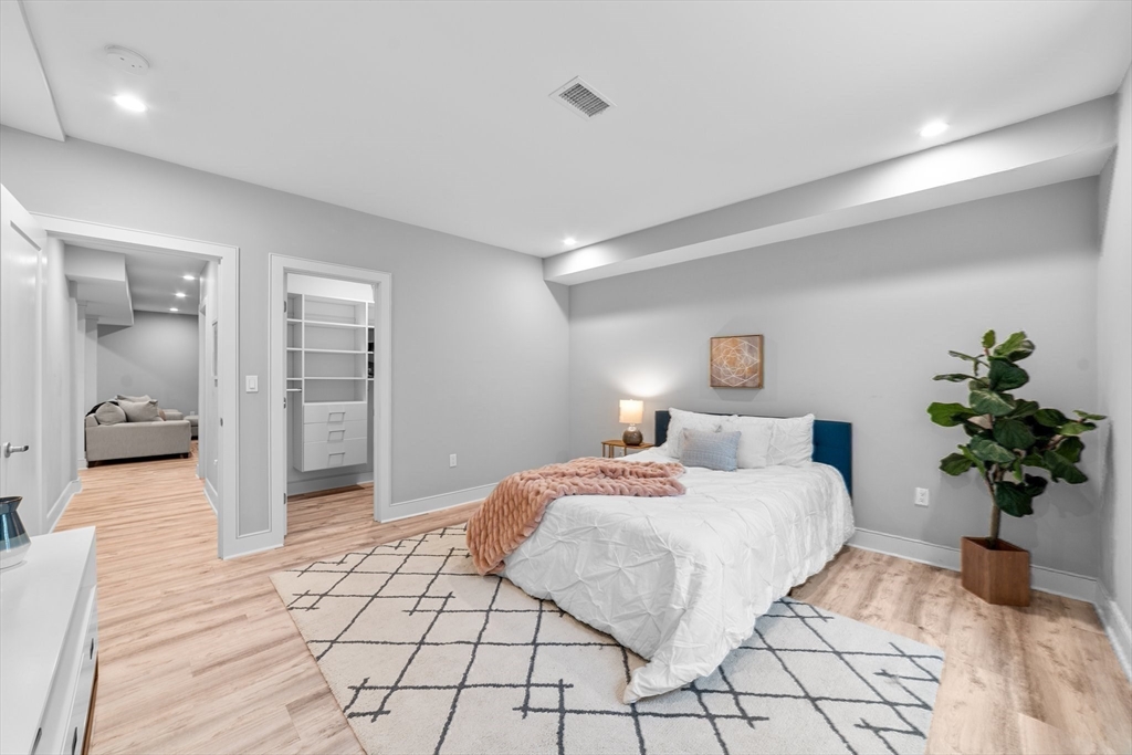19 Boulder Road Newton, MA 02459 - Photo 31 of 42 a bedroom with a large bed and a potted plant