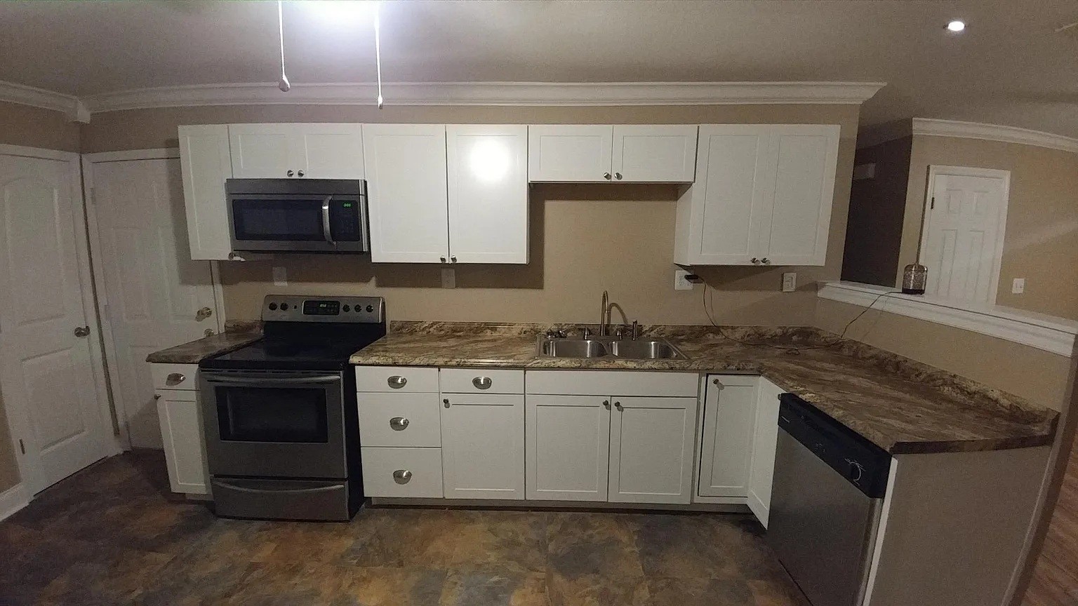 3836 Youngstown Road Chattanooga, TN 37406 - Photo 2 of 7 a kitchen with granite countertop white cabinets and stainless steel appliances
