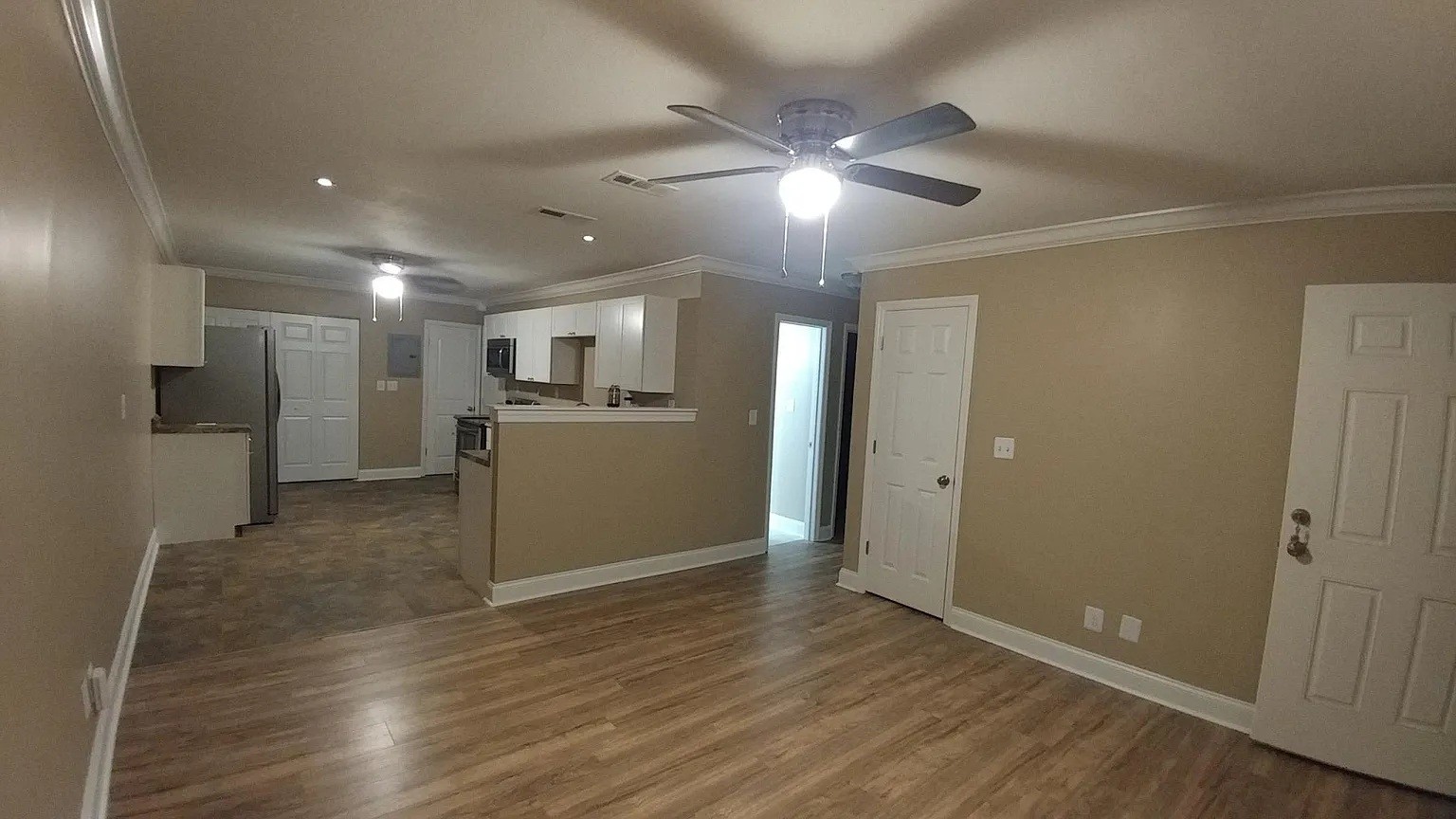 3836 Youngstown Road Chattanooga, TN 37406 - Photo 3 of 7 wooden floor in an empty room with kitchen view