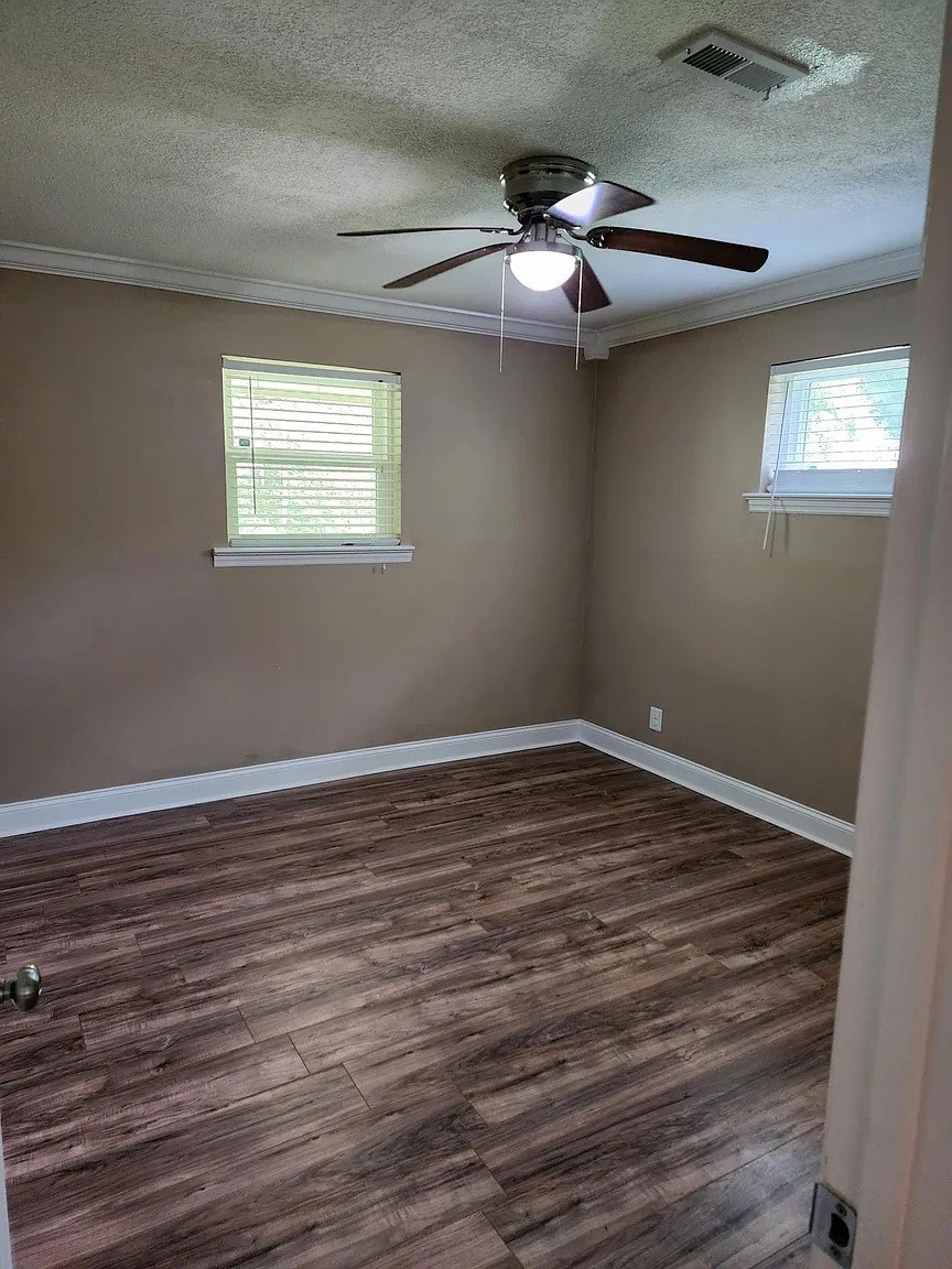 3836 Youngstown Road Chattanooga, TN 37406 - Photo 6 of 7 a view of an empty room with wooden floor and a window