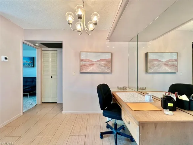 a view of a dining room with furniture and chandelier