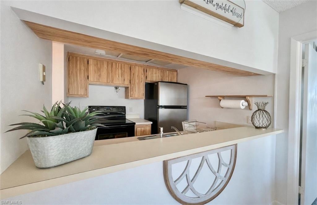 4293 27th Court Southwest, Unit 203 Naples, FL 34116 - Photo 12 of 22 a bathroom with a potted plant and a sink