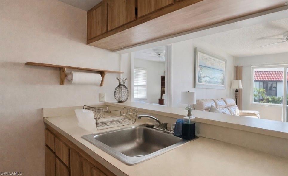 4293 27th Court Southwest, Unit 203 Naples, FL 34116 - Photo 13 of 22 a bathroom with a sink and a mirror