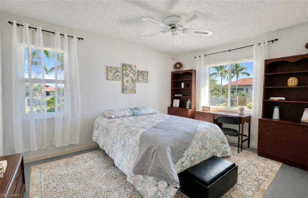 4293 27th Court Southwest, Unit 203 Naples, FL 34116 - Photo 15 of 22 a bedroom with a bed furniture and a window