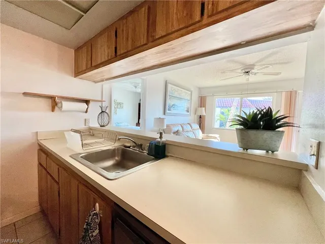 a kitchen with a sink and a refrigerator