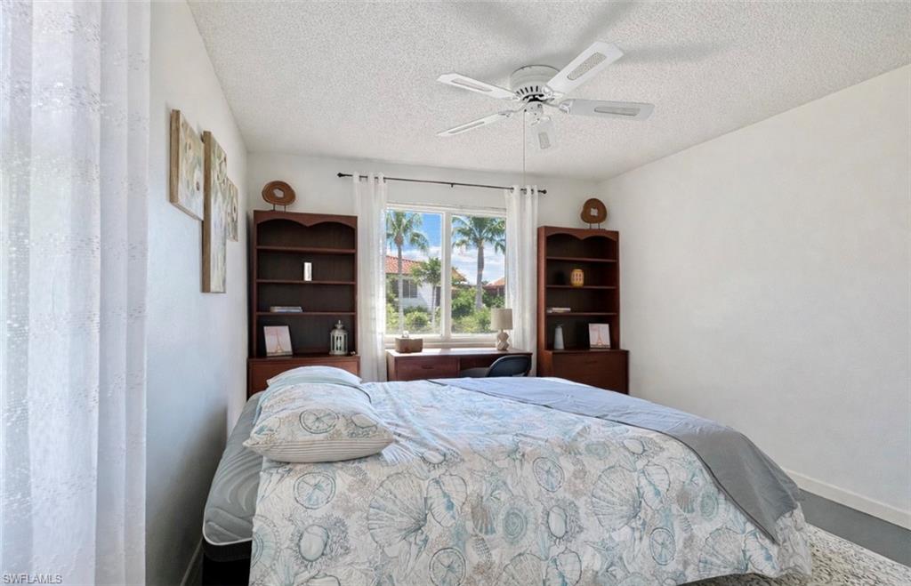 4293 27th Court Southwest, Unit 203 Naples, FL 34116 - Photo 16 of 22 a bedroom with a bed and a window