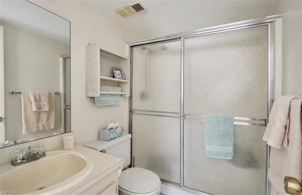 4293 27th Court Southwest, Unit 203 Naples, FL 34116 - Photo 17 of 22 a bathroom with a sink toilet and shower