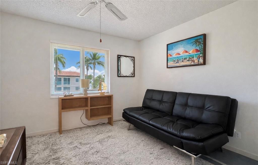 4293 27th Court Southwest, Unit 203 Naples, FL 34116 - Photo 18 of 22 a living room with furniture and a window