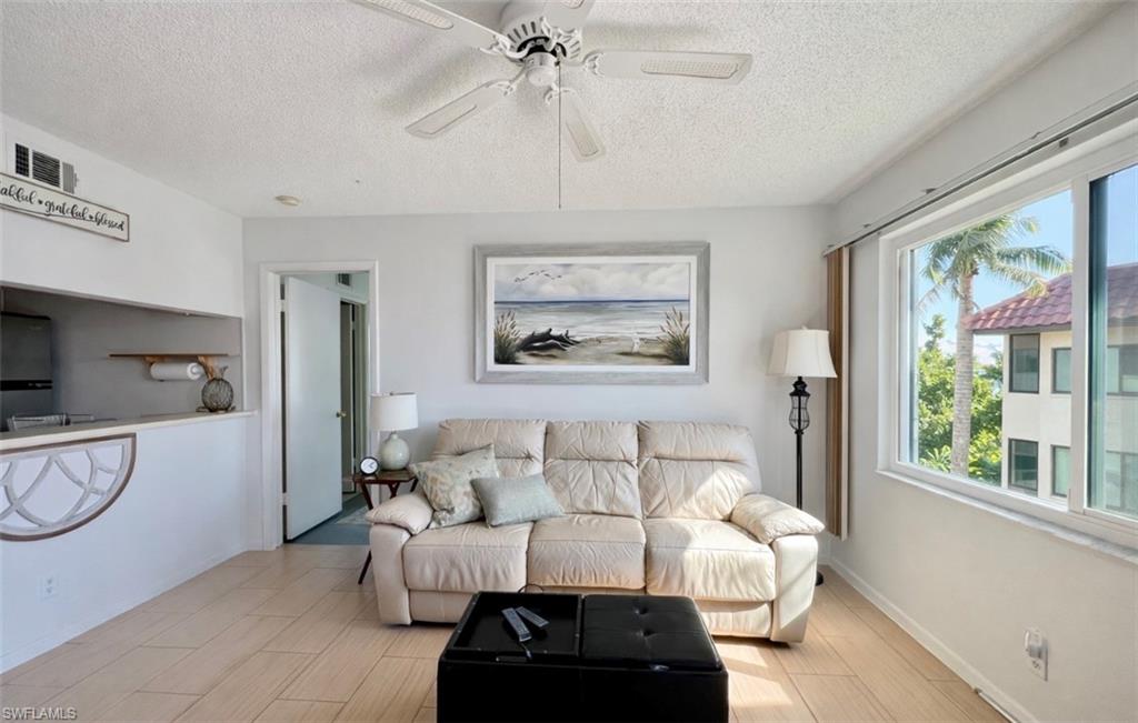 4293 27th Court Southwest, Unit 203 Naples, FL 34116 - Photo 7 of 22 a bed room with furniture and a window