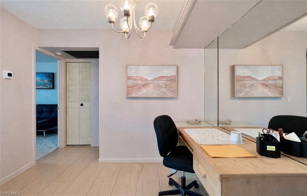 4293 27th Court Southwest, Unit 203 Naples, FL 34116 - Photo 9 of 22 a view of a workspace with furniture and a window