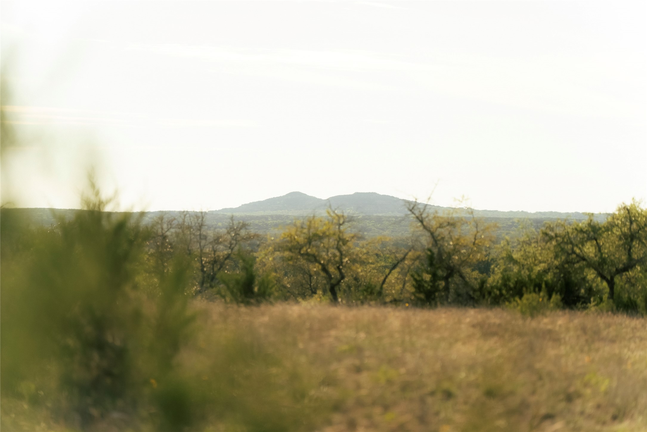 157 Chick Ranch Road Blanco, TX 78606 - Photo 16 of 34 a view of a lake with a mountain in the background