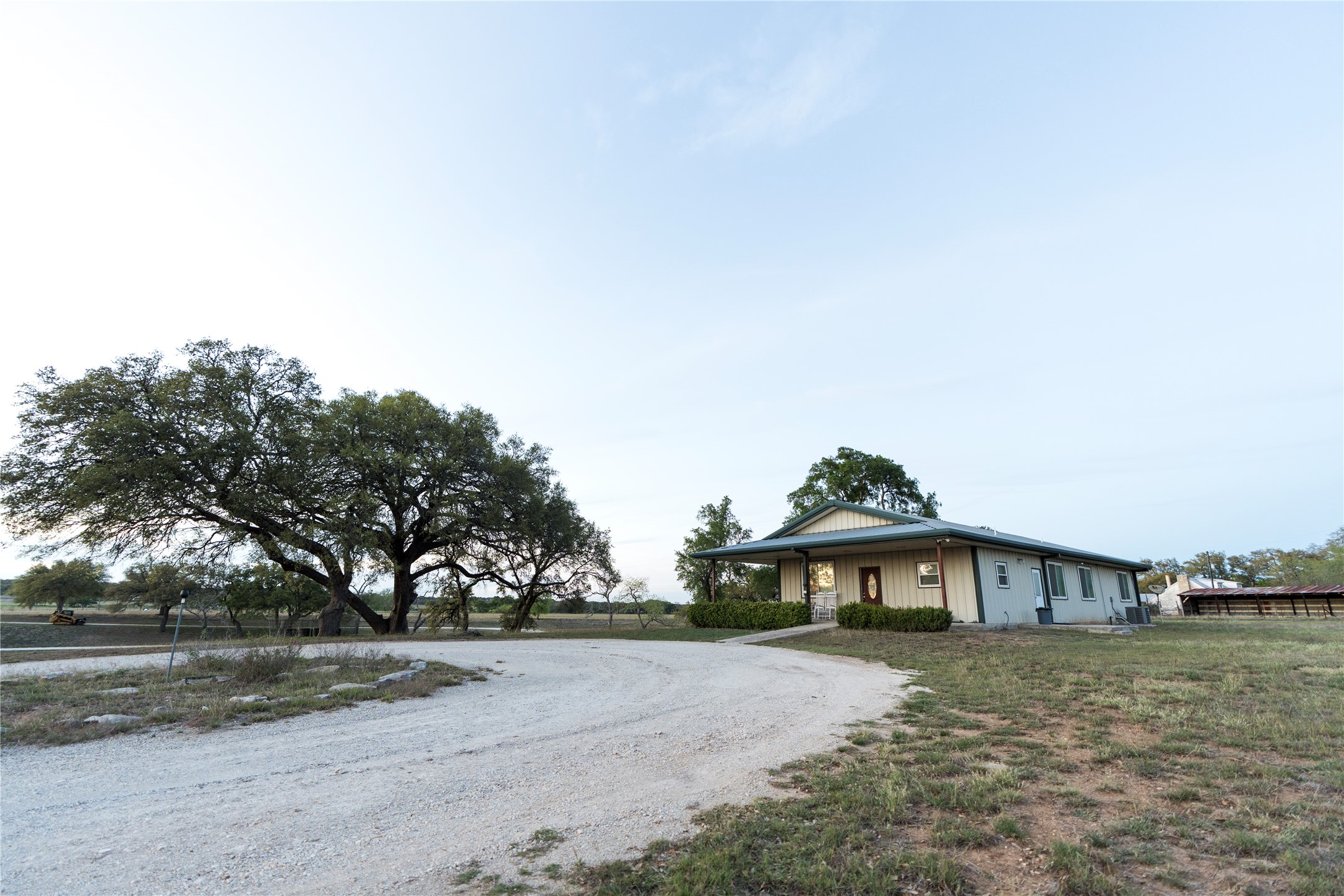 157 Chick Ranch Road Blanco, TX 78606 - Photo 7 of 34 a view of a big house with a yard and large trees