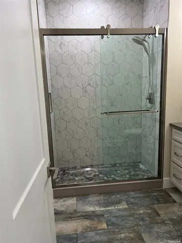 a bathroom with a glass shower door