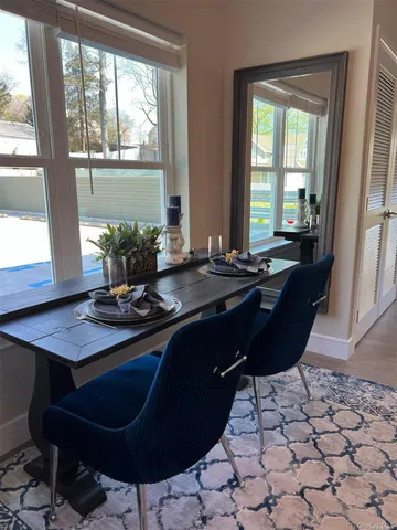 a room with a table chairs and wooden floor