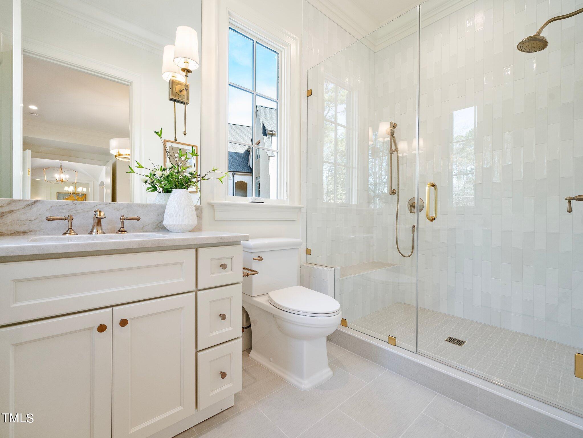 5400 Alpine Drive Raleigh, NC 27609 - Photo 36 of 70 a bathroom with a shower sink vanity and toilet