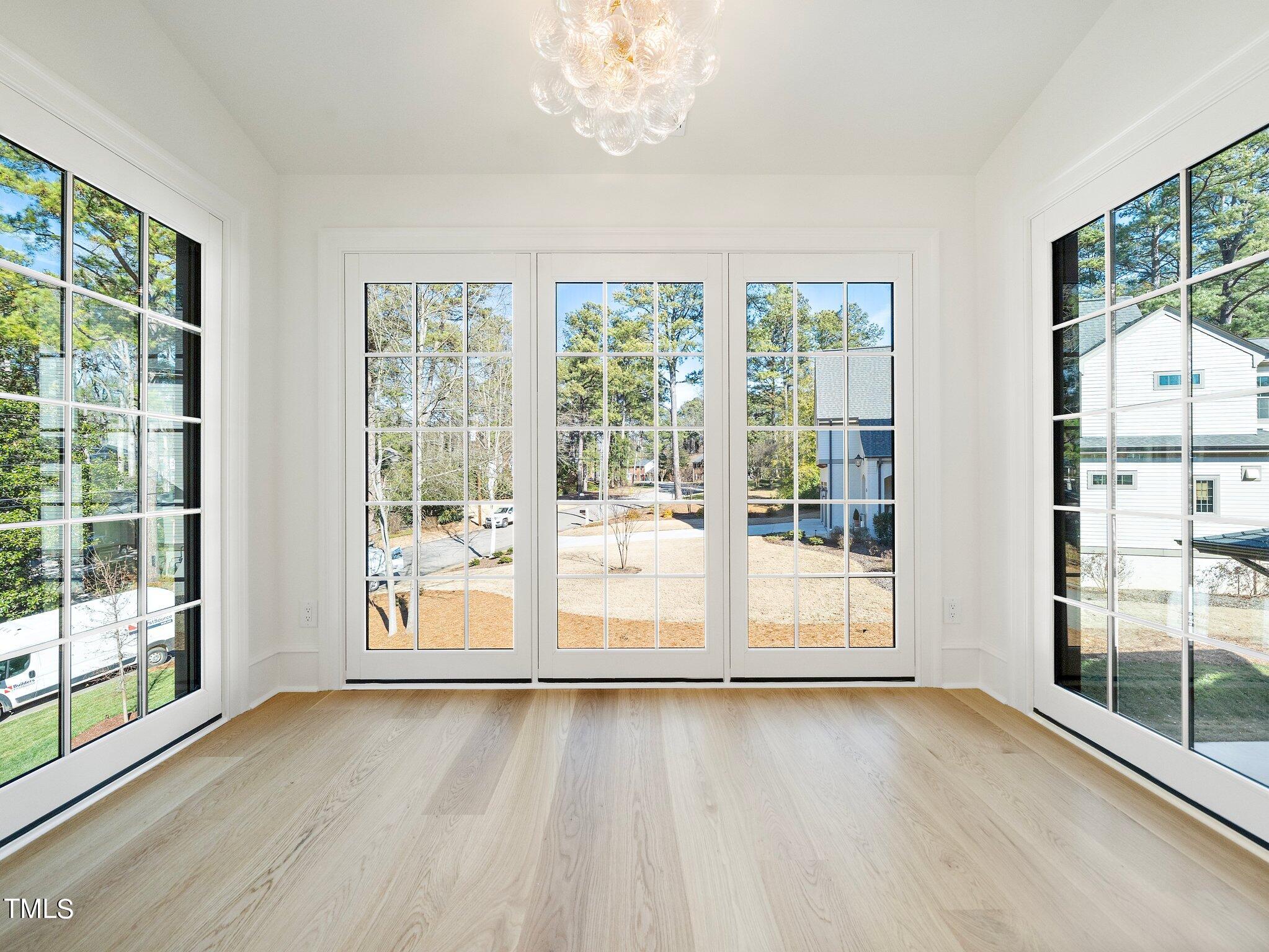 5400 Alpine Drive Raleigh, NC 27609 - Photo 42 of 70 a view of an empty room with wooden floor and a window