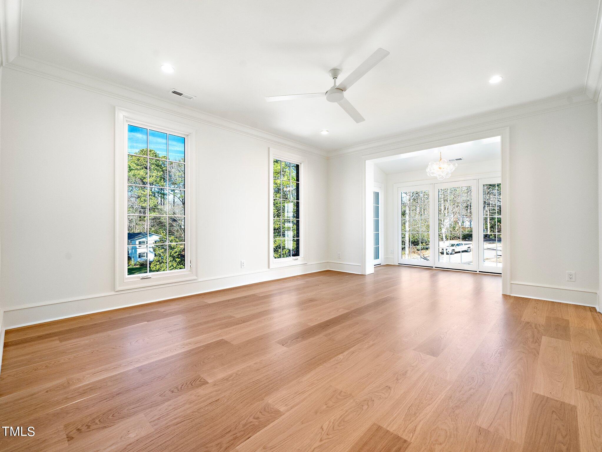 5400 Alpine Drive Raleigh, NC 27609 - Photo 44 of 70 a view of an empty room with wooden floor and a window