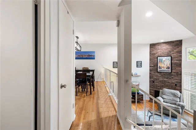 a view of a hallway with furniture and floor to ceiling window