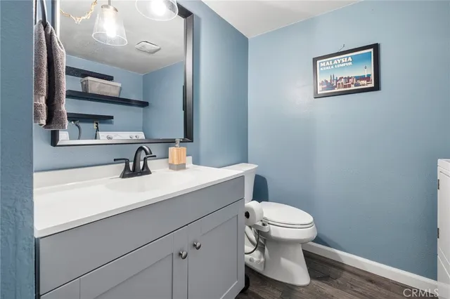 a bathroom with a toilet a sink and mirror