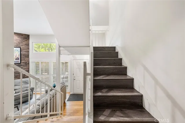 a view of staircase with white walls and windows