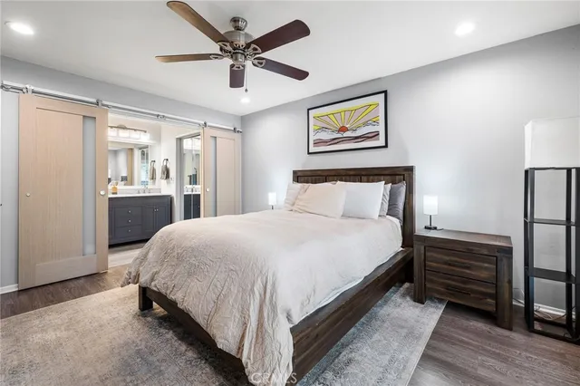 a bedroom with a large bed and a chandelier