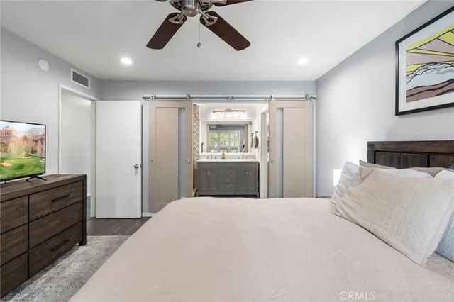 a bedroom with a bed and a television