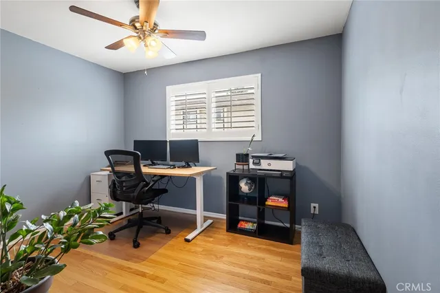 a view of a workspace with furniture and a window
