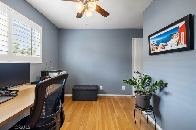 a view of a workspace with furniture and a potted plant