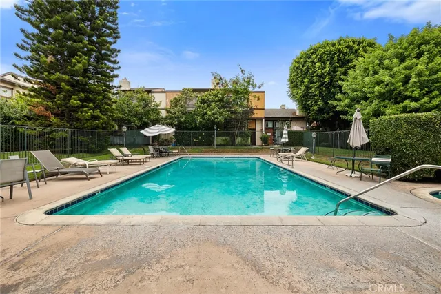 a swimming pool with outdoor seating and yard