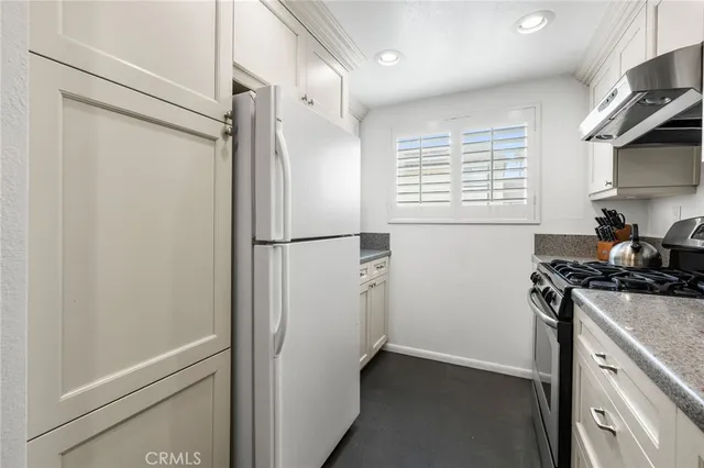 a kitchen with a refrigerator and a stove