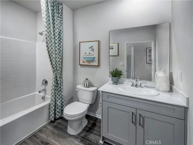 a bathroom with a granite countertop toilet a sink and a bathtub