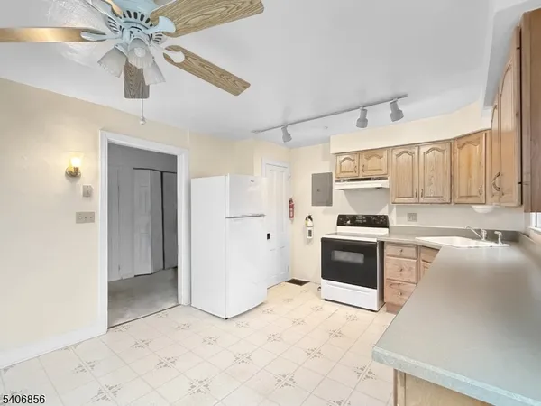 a kitchen with stainless steel appliances a refrigerator sink and cabinets