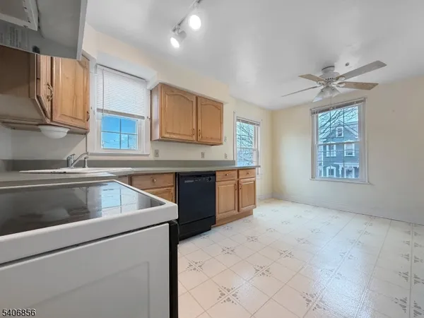 a kitchen that has a sink and a stove in it