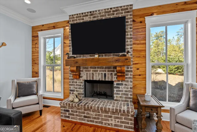 a kitchen with stainless steel appliances granite countertop a sink dishwasher and white cabinets with wooden floor