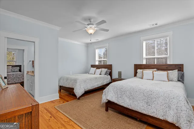 a kitchen with a refrigerator and white cabinets