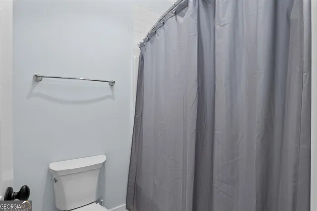 a living room filled with furniture and a wooden floor