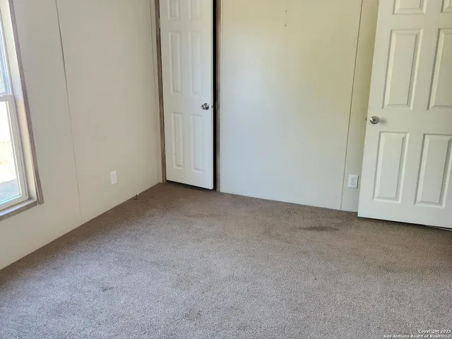 a view of an empty room and a window