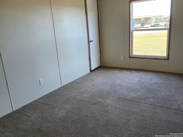 a utility room with wooden floor washer and dryer