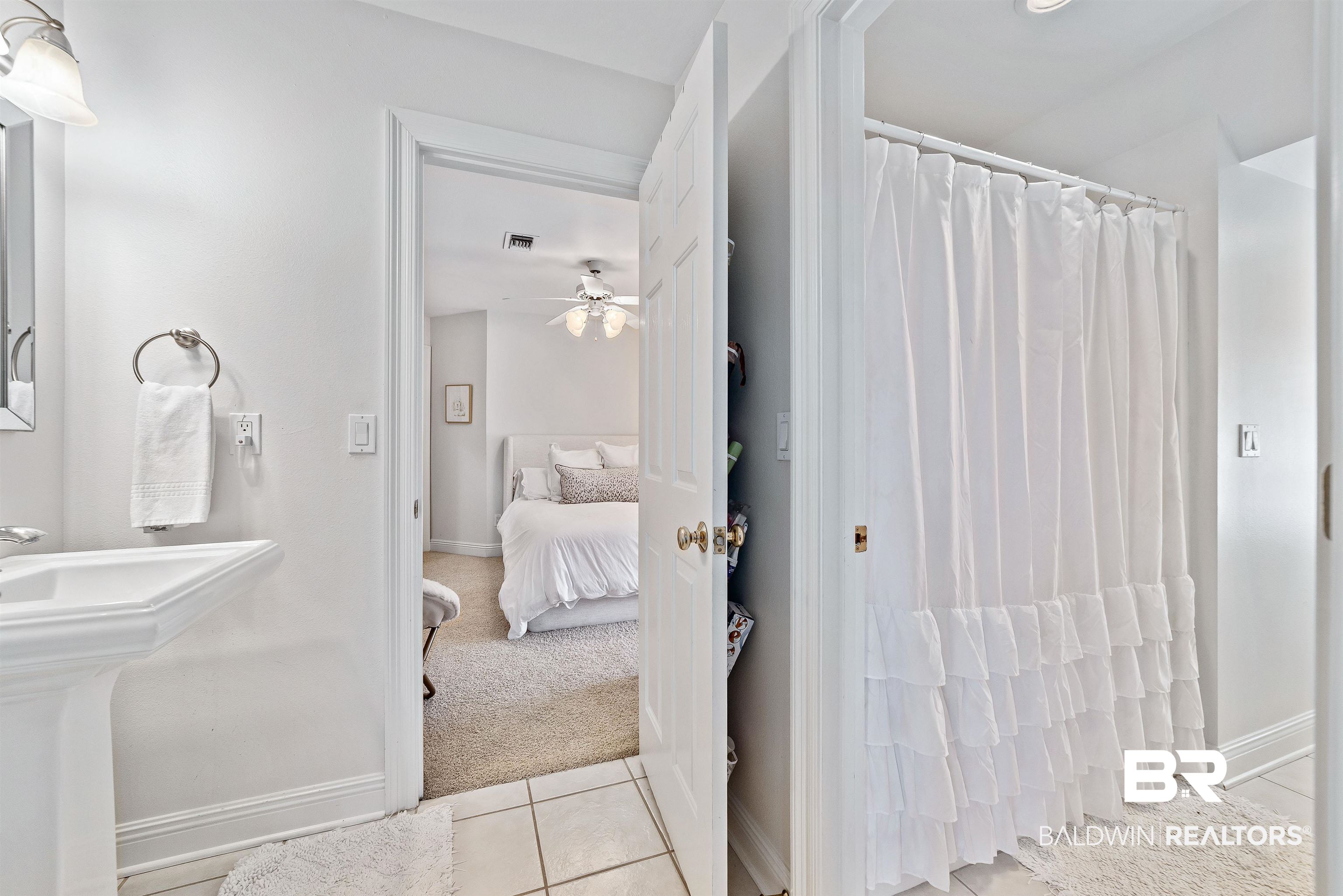 6630 East Quarry Drive Elberta, AL 36530 - Photo 30 of 63 Bathroom with light tile patterned floors, light colored carpet, ensuite bath, curtained shower, and a ceiling fan