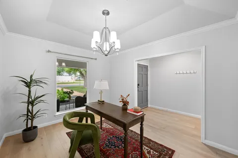 a living room with furniture and a chandelier